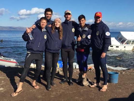 Jacksonville Beach Ocean Rescue members Nicki Emerson (second from left) and Vasili Pleqi (behind her) with other international lifeguards in Lesvos, Greece. The lifeguards have rescued more than 600 refugees since Jan. 2. (photo submitted)