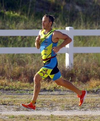 Aaron Austin nears the finish line as he completes the 3.1-mile run to win the third of last year’s three BFAST races in July. The 31-year-old Austin was also men’s overall winner of the June 2015 race. (photo by Rob DeAngelo)