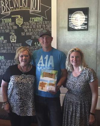 Amy Carpenter from the Florida Department of Citrus (left) and Kara Pound from the St. Augustine Distillery (right) visit with Matt Stevens, manager of A1A Cocktail Trail Program, to unveil the new A1A Cocktail Trail program. (photo submitted)