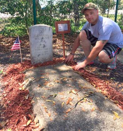 Neptune Beach resident Brian Bausch is working to improve veterans' grave-markers in Lee Kirkland Cemetery, many of which are overgrown, buried or broken. (photo by Chelsea Wiggs)