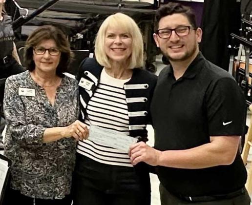 Claire Gertz, community giving chair, and Renee Favo, treasurer, present FHS Band Director Randy Salinas with a check.