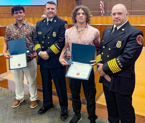 Gabriel Caez (left) and Kyle Atwater (second from right) were recognized by St. Johns County Fire Rescue Chief Scott Bullard and Operations Chief Patrick Welch. (photo submitted)