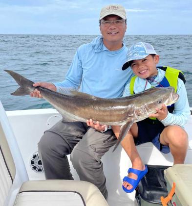 Allen Andone and his grandson, Roman, celebrate a cobia caught on Roman's first trip offshore. (photo submitted)