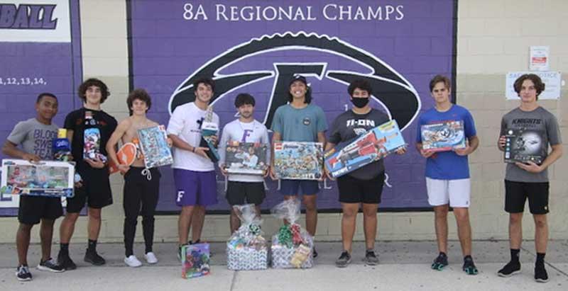 Shown with toys and food baskets are Fletcher baseball team members Casmond Relaford, Caden Wilson, Flynn Pausche, Gabe Moorer, Joey Britt, Matt Clements, Bryce Virata, Connor Sutherland and Jacob Harman. (photo submitted)