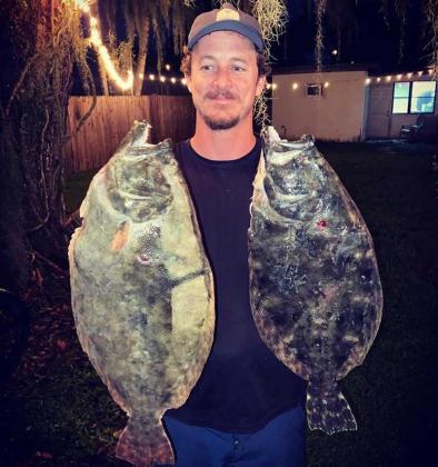 Ryan Sullivan with a great pair of flounder from a night gigging this week. (photo submitted)