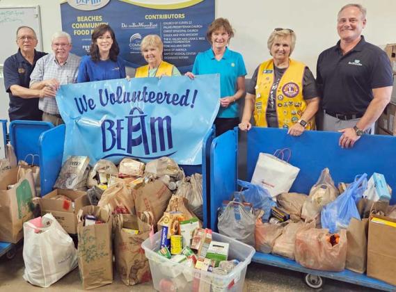Dropping off food donations at the BEAM food bank are, from left, John Mullins and Bobby Bass of the Exchange Club; Jennifer Logue of the Rotary Club of Ponte Vedra Beach; Susan Dixon of the Jacksonville Beach Lions Club; Cathryn Hagan of the Oceanside Rotary Club; Pat Schaaf of the Jacksonville Beach Lions Club; and Mike Johnson of the Rotary Club of Ponte Vedra Beach. (photo submitted)