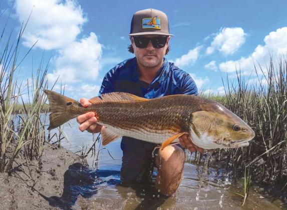 Beaches local Will Vought with a nice redfish he caught in the ICW creeks this week.
