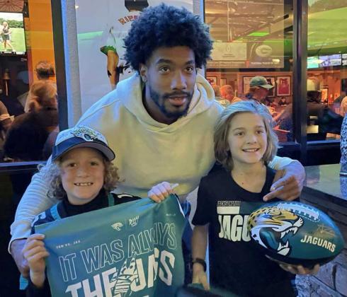 Cooper Reber and Fisher Proffitt are shown with Jacksonville Jaguars safety Andre Cisco at Sneakers in Jacksonville Beach for Jags Report Live. (photo submitted)