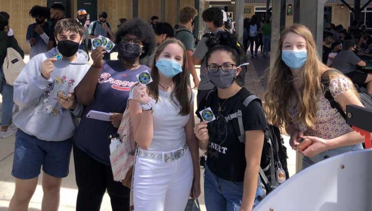 Nease students stop by the booth for Nease Beaches Go Green Club and grab stickers for their environmental club. (photo submitted)