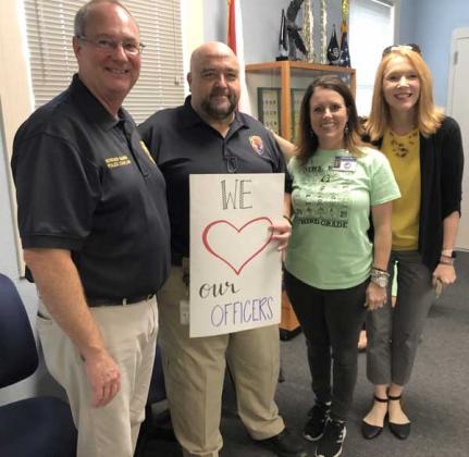 Beaches Chapel Church Senior Pastor Howard McMinn (the police chaplain for Neptune Beach), Commander Gary Snyder, Lower School Administrator Allison Bass and School Administrator Edi Wohlgemuth. (photo submitted)