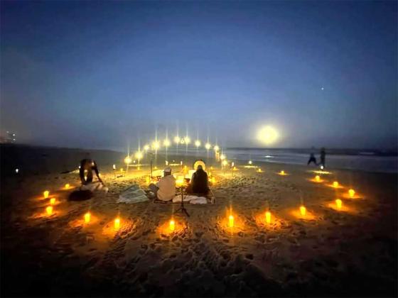 Sound practitioner Gra Alessi Doherty conducts a beachfront sound bath in Jacksonville Beach.