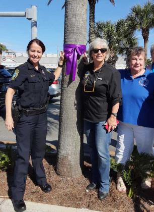 Atlantic Beach Police Chief Michelle Cook, left, and Mayor Ellen Glasser, center, join a woman's club member.