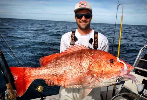Captain Brandon Ingalls of Stay Tight Charters holds a massive red snapper he caught on a jig. (photo submitted)