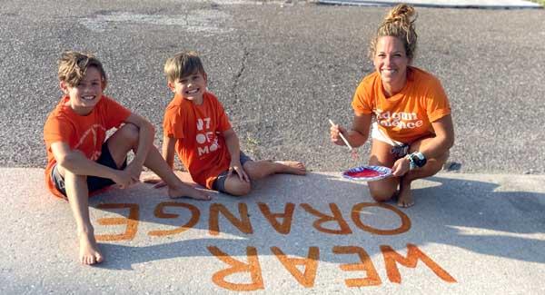 Katie Hathaway and children wear orange to honor the victims of gun violence. (photo submitted)