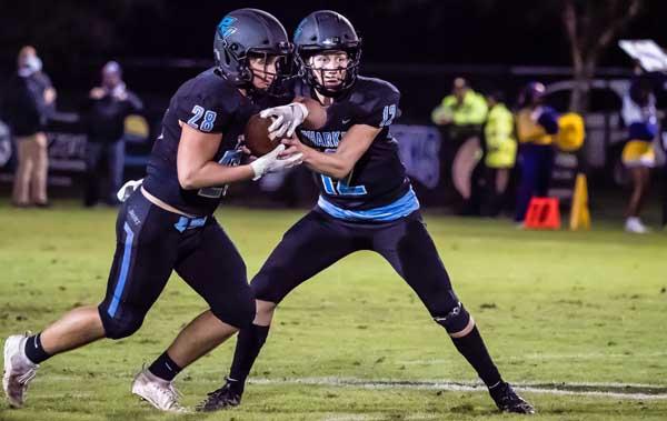 Ponte Vedra QB R.J. Glod (12) hands off to running back Collin Magill (28) during Friday's high school football playoff game. (photo by Jim Brady)