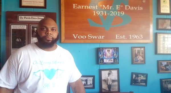 Lewis Washington, the youngest child of the late Earnest Davis, transformed his father's table into the centerpiece of a memorial wall at the Voo Swar in Atlantic Beach.