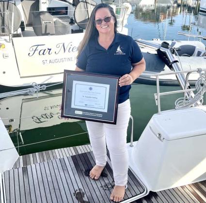 Rose Ann Points holds the new Autism Certification St. Augustine Sailing recently received. (photo submitted)