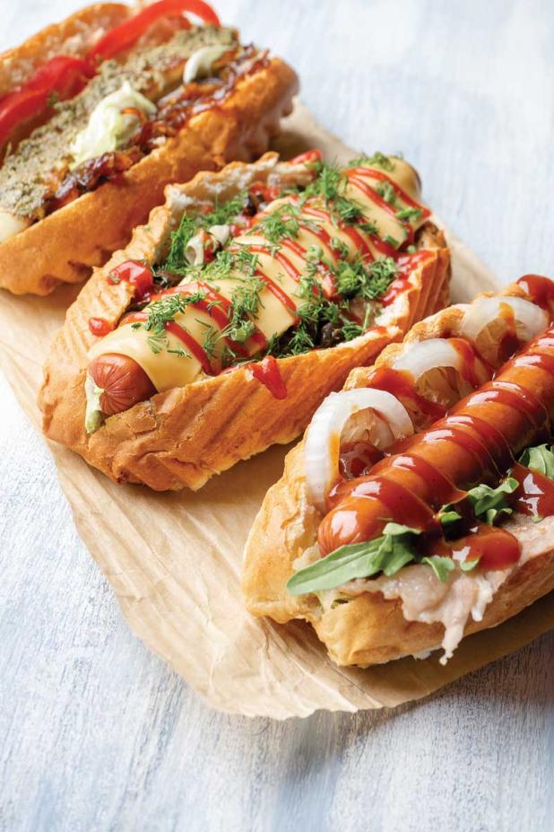 Mainstays on game day, hot dogs and bratwursts can be easily topped and customized. (photo courtesy of Getty Images)