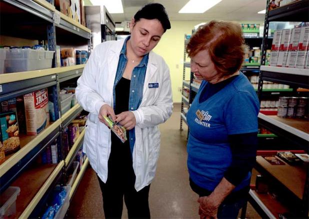 A BEAM dietician and volunteer work together in the Mayport Pantry. (photo submitted)