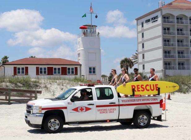  Members of the Volunteer Life Saving Corps patrol the beach.