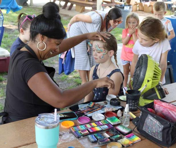 Children line up to have their faces painted at the Beaches Back-to-School Book Bash. (photo submitted)