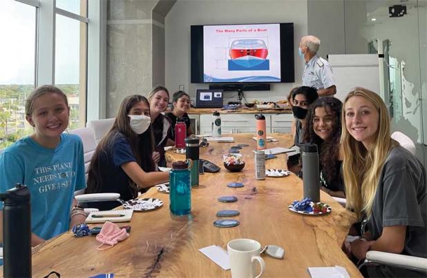 Anna Champagne (Nease), Emily Favorite (Tocoi), Madeline Russo (Ponte Vedra High School), Sia Dewan (PVHS), Lilly Davis (Nease), Rani Mehta (Nease), Ranya Benchaaboune (Nease), Mary Pace-Balzan and Officer Rick with the U.S. Coast Guard. (photo submitted)