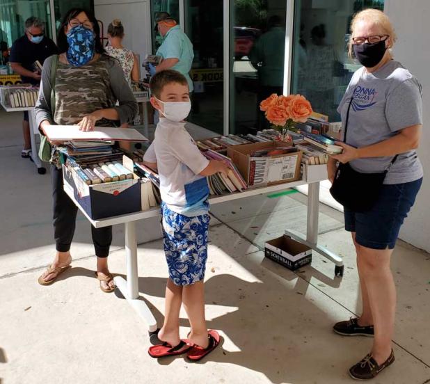 Book lovers browse through the selection at the Oct. 24 pop-up book sale at the Beaches Branch Library in Neptune Beach. (photo by Barbara Sperbeck)