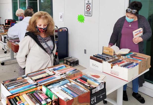 Book lovers browse through used books at a recent Friends of the Beaches Branch Library (FOBBL) pop-up sale. (photo by Barbara Sperbeck/Friends of the Beaches Branch Library)
