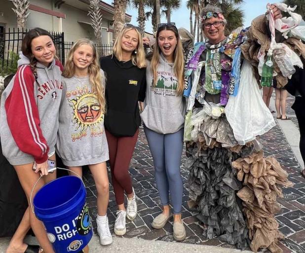 Student volunteers take a picture with Beaches Go Green's Plastic Monster at the Beaches Go Green Holiday Cleanup. (photo submitted)