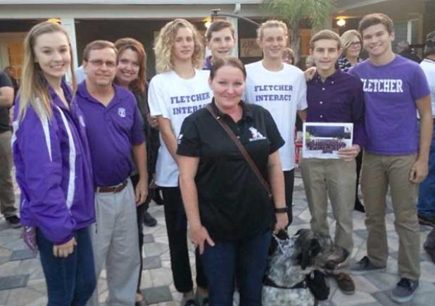 K9 Brownie is shown with warrior Michelle (center), along with Interact members Mark Caldwell, Eli Reeves, Gabe Reeves, Jaxon Naramore, President Matthew Caldwell, Vice President Ashley Peterson and Brown. (photo submitted)