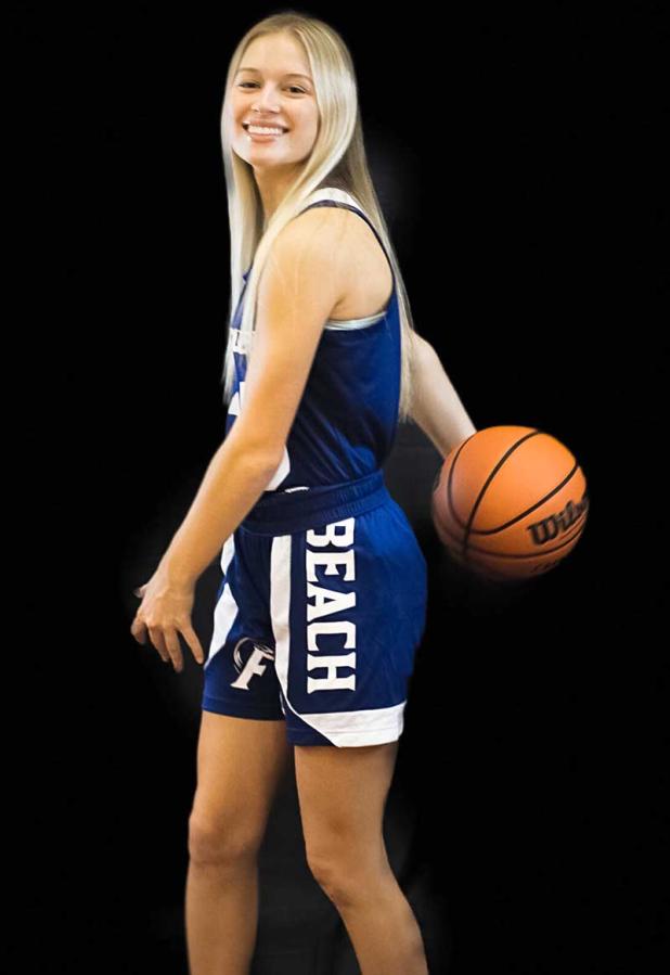 Elana Espenship displays the ball she used to reach the 1,000-point mark in her high school basketball career. (photo submitted)