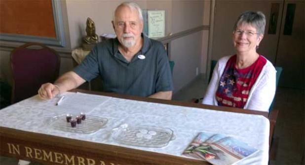 Members Lyle Reimann and Rebecca Zellars were among those who served in the hallway near the polling place at the church.  (photo by Linda Borgstede)