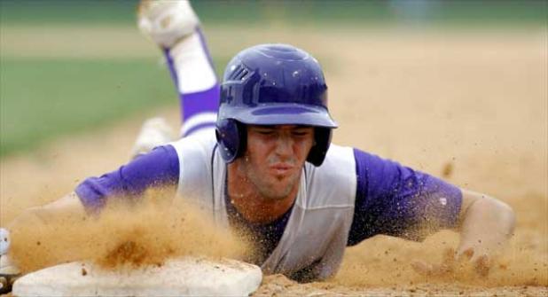 Fletcher High’s Ryan Ayrey dives back to first base on a pickoff attempt during last Friday night’s baseball game against visiting Ponte Vedra High. Ayrey was safe on the play. The Sharks plated a pair of runs in the top of the second and one more in the third en route to a 3-1 victory. (photo by Rob DeAngelo)