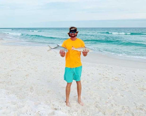 William Joseph Peckham holds a Florida pompano (left) and a record-breaking 2.4-pound Gulf kingfish/whiting caught off Pensacola Beach April 18. (photo submitted)