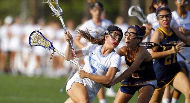 Sharks attacker Ellie Lecker (7) breaks for the net while guarded by St. Thomas Aquinas defender Mallory Civil during their game on March 30 at the Shark Tank. Ponte Vedra rolled to 13-8 victory with Lecker scoring a pair of goals. (photo by Rob DeAngelo)