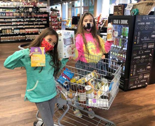 Elementary students from Montessori Tides School shop at Native Sun for the school’s annual USO Food Drive. (photo provided by Montessori Tides School)