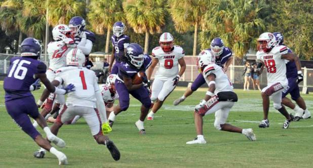 Dre Harold fights for yardage in the Sept. 8 game against Jackson. (photo by Jeanell Wilson)