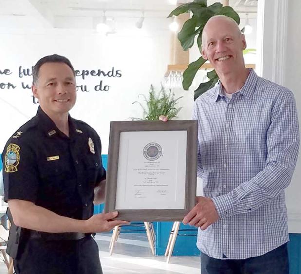 Atlantic Beach Police Chief Vic Gualillo accepts an award from Beaches Exchange Club President Jim Hanson. (photo submitted)