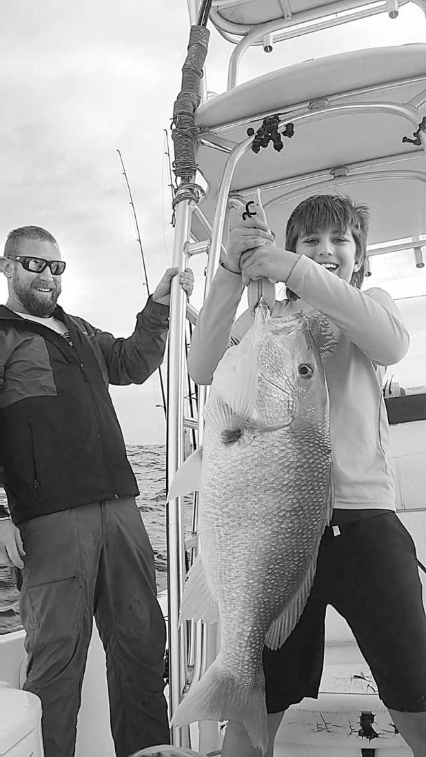 Hank Hnath celebrates his 10th birthday with Captain Christian and hopes to see this Red Snapper again during the season. (photo submitted)