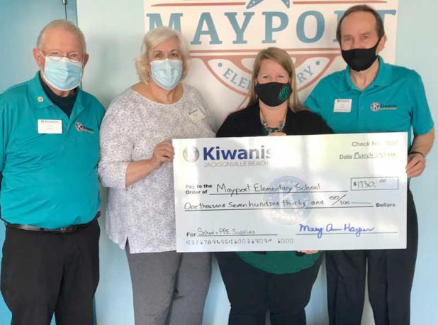 Kiwanis Secretary Chuck Watson, Kiwanis President Mary Ann Harper and Kiwanis Bob Burch present their donation to Mayport Elementary Principal Katie O’Connell (second from right). (photo submitted)