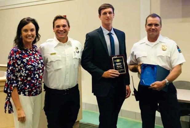 Lifeguard of the Year Christopher Daniels, second from right, is shown with Mayor Chris Hoffman, Max Ervanian and Rob Emahiser with the Jacksonville Beach lifeguards.