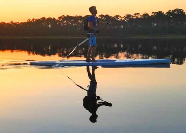 Kurtis Loftus on a paddle board as part of the Island Beast, a 64.5-mile solo triathlon he created. (photo submitted)