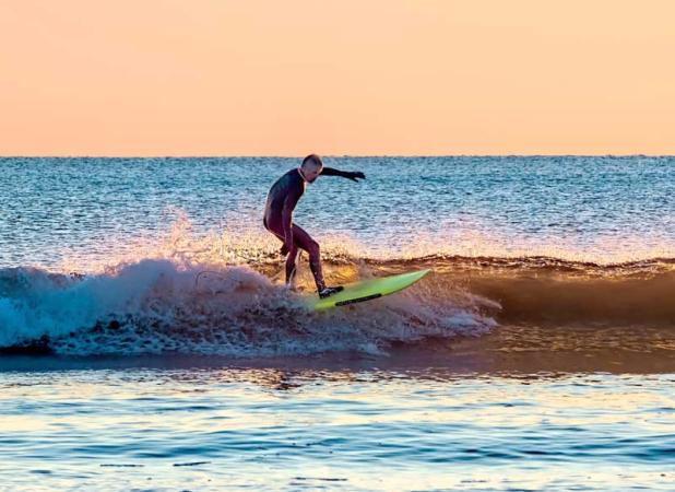Kurtis Loftus surfed 638 waves in 33 hours to raise funds for Deck the Chairs. (photo by Roxanne DeSousa)
