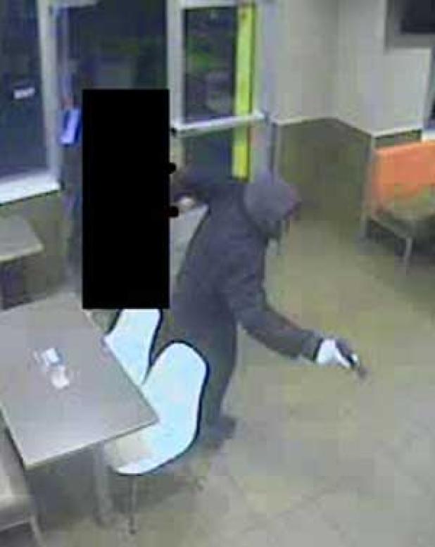 An image from a video surveillance shows a suspect with a handgun. (image submitted by police)