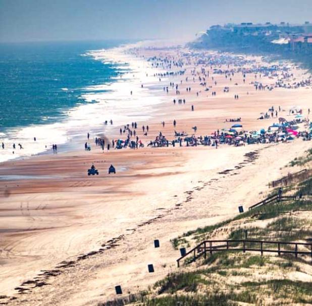 The St. Johns County and Duval County line is shown at the beach March 28. On the St. Johns County side, beachgoers fill the beach prior to the closing of all St. Johns county beaches March 29. (photo submitted)