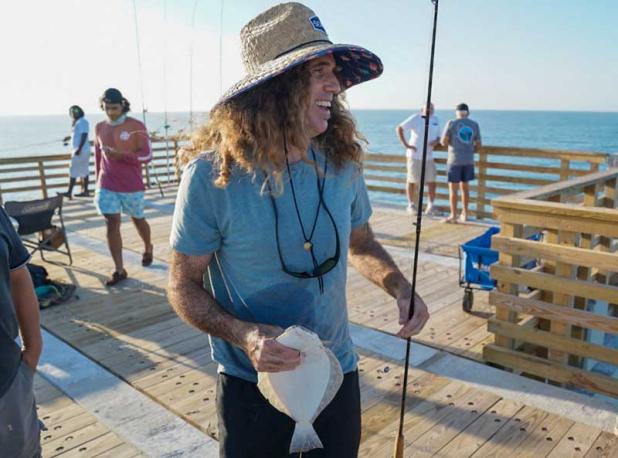 A local angler with his catch on the morning the Jacksonville Beach pier opened to fishing. (photo by Chris Shultz)