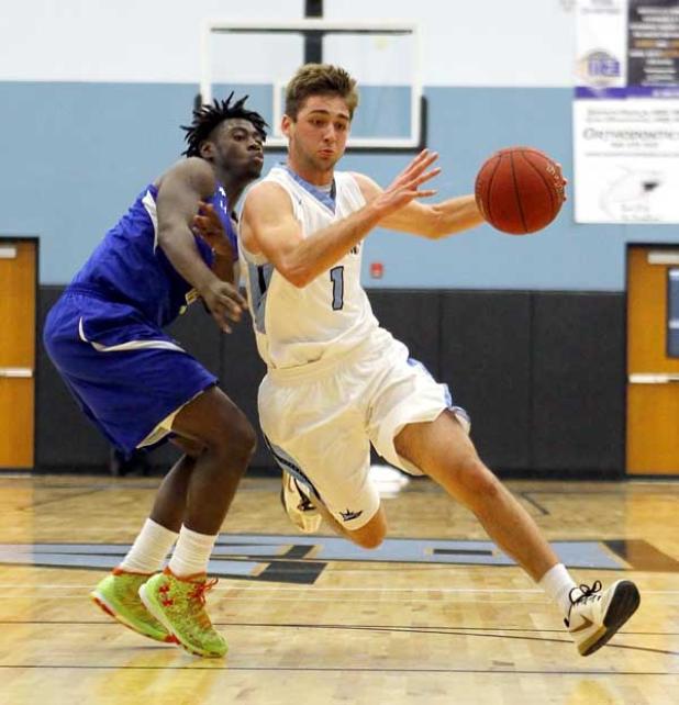 Ponte Vedra High’s J.D. Pirris (1) drives the lane en route to scoring two of his game-high 21 points in last Friday’s District 5-5A championship game against visiting Palatka. The Sharks staged a second-half rally to beat the Panthers 60-52 in front of a raucous crowd at the Shark Tank. (photo by Rob DeAngelo)