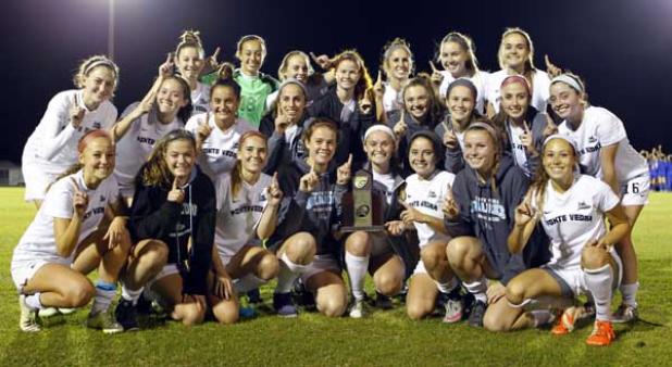 Ponte Vedra High girls soccer players pose with the trophy following their 3-0 victory over Clay High to secure the District 4-3A championship last Friday night at Menendez High. It was a second straight district title for the Sharks who begin the state playoffs tonight at home against Paxon with opening kick at 7 p.m. (photo by Rob DeAngelo)