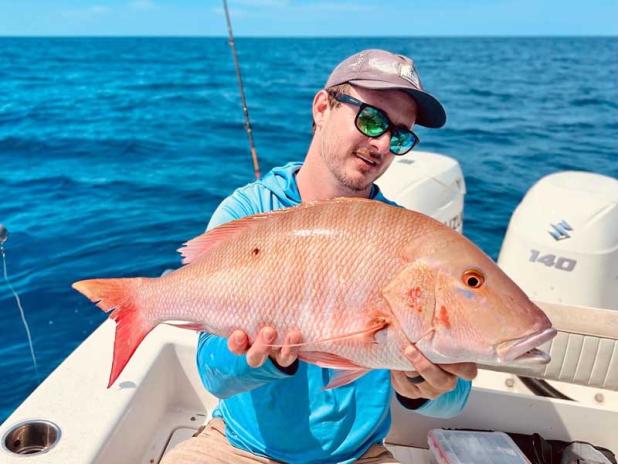 Ryan Sullivan, owner of local marine fabrication shop Florida Fabworks, shows off a mutton snapper he caught last month fishing off Jacksonville. (photo submitted)