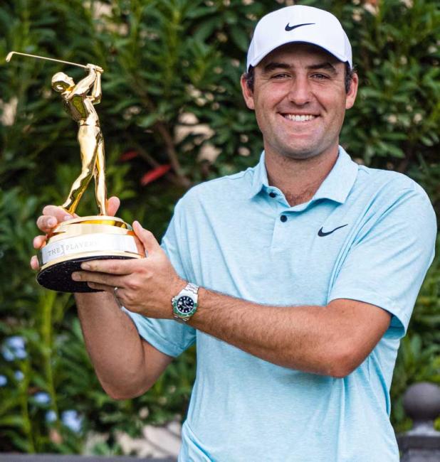 Scottie Scheffler stands with trophy after his victory at THE PLAYERS. (photo by EVAN O'HARA)